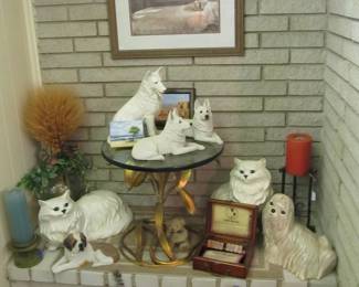 Animal lovers! We have cute cat & dog statues. Also, a stunning vintage gilded lily glass top table by designer: Arthur Court