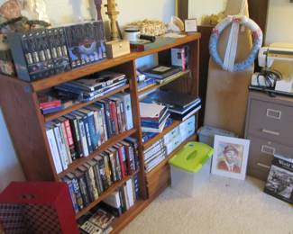 Wooden bookshelf storage is full of great books! Military history collector books, novels & more.