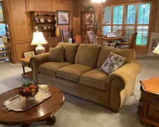 Comfy sofa with a round coffee table that has a swivel base