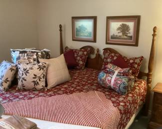 King poster bed with cute coverlet and pillow shams