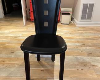 $45. Black leather chair from Theodores. 17"w x 17"d x 41"h. Dear height from floor is 19". Has a few nicks.