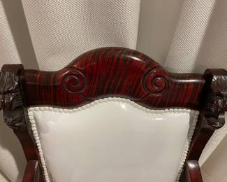 Detail of top wood, modern white nailheads and carved lions heads