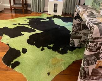 Now $150. Was $300. Dyed cowhide rug in greens and black. Size ranges due to natural hide, but is approximately 92"x92" at furthest points. Super soft fur.