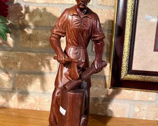 carved wooden cowboy chopping wood