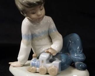 1012	NAO PORCELAIN FIGURINE, BOY PLAYING W/TRAIN, APPROXIMATELY 5 IN HIGH
