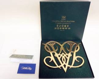 1105	VIRGINIA METAL CRAFTERS, COLONIAL WILLIAMSBURG 10-10 QUEEN ANNNE CYPHER TRIVET, SOLID BRASS, APPROXIMATELY 9 IN X 10 IN
