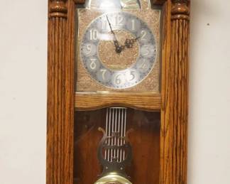 1157	HOWARD MILLER QUARTZ WALL CLOCK IN OAK & BURLED WALNUT CASE W/REEDED HALF COLUMNS, APPROXIMATELY 5 1/2 IN X 14 IN X 35 IN
