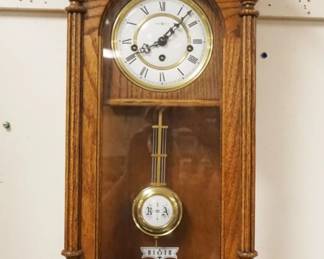1156	HOWARD MILLER KEY WOUND WALL CLOCK IN SOLID OAK CASE, APPROXIMATELY 6 IN X 12 IN X 32 IN HIGH
