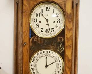 1159	HOWARD MILLER CALENDAR CLOCK IN OAK CASE, APPROXIMATELY 18 IN X 8 IN X 30 IN HIGH
