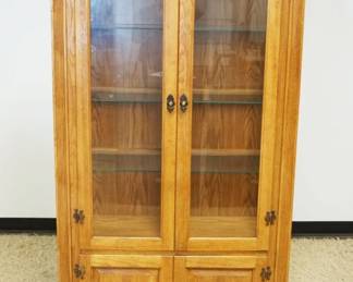 1170	SOLID OAK 4 DOOR CURIO CABINET, 2 GLASS OVER 2 SOLID, HAS HALF REEDED COLUMN SIDES, INTERIOR LIGHTS & GLASS SHELVES, APPROXIMATELY 18 IN X 43 IN X 74 IN HIGH
