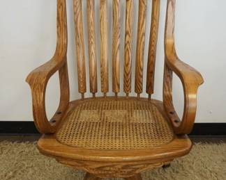 1180	SOLID OAK PRESSED BACK SWIVEL DESK CHAIR, CANE SEAT
