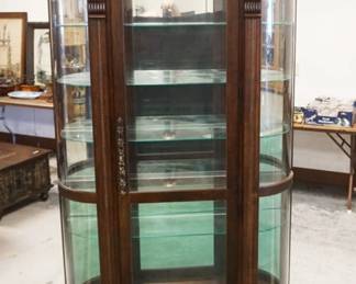 1185	PULASKI CURVED & BEVELED GLASS CRYSTAL CABINET, WALNUT ON PAW FEET W/INTERIOR LIGHTS & ADJUSTABLE GLASS SHELVES & MIRROR BACK, APPROXIMATELY 49 IN X 17 IN X 81 IN HIGH
