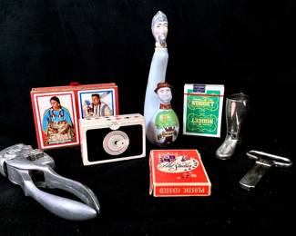 JIFI907 Vintage Saloon Collectibles Sureda, Spain, hand painted, two headed, whiskey bottle. Large cast aluminum nutcracker, might be a depiction of Jerry Lewis or Jimmy Carter? Silver riding boot shot glass. Monopol, West Germany bottle opener. Jack Ross Royal Lahaina invitational playing cards, unopened. Great Northern Railway playing cards both decks in unopened factory sealed plastic. Unopened pack Carson City Nugget , NV playing cards. Pack opened Fifty-Two Art Studios plastic coated playing cards.