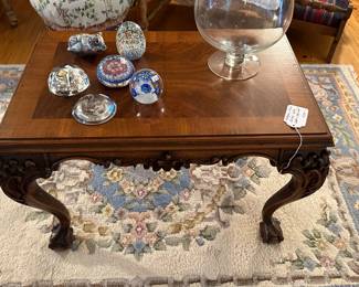 Mahogany finish carved table, ball and claw feet