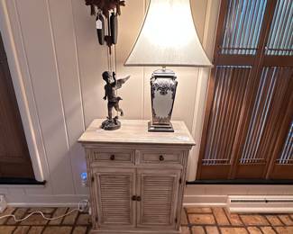2 Drawer/2 Door Cabinet, Ceramic Table Lamp, Bronze Cupid Statue, Cuckoo Clock