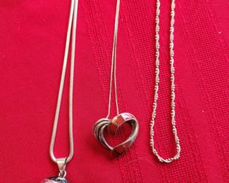 Sterling Silver and Inlay. In the middle is an inlay of Coral. 