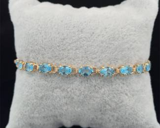 Oval Natural Blue Topaz Single Row Hinge Link Tennis Bracelet in Yellow Gold