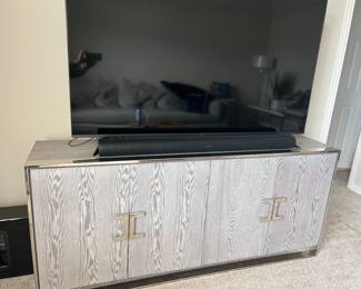 - 65in UHD LG Smart TV
- Gray wood & silver entertainment center
