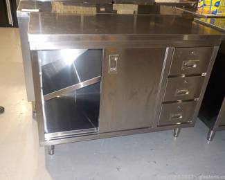 Stainless Steel Work Table with 3 Drawers and 2 Shelves Behind Sliding Doors