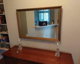 nicely-framed beveled glass mirror and matching vanity lamps