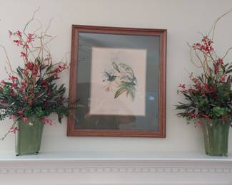 framed and matted art and matching sconces with dried flower arrangements