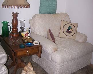 Cream colored upholstered chair, drop leaf end table