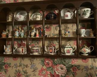many teapots/creamers.small plates  and an abundance of Airline creamers and trays