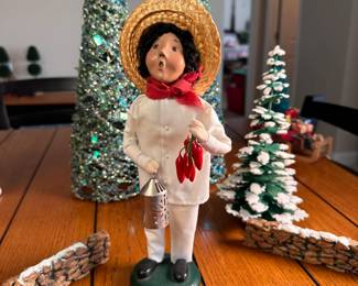 Byers' Choice caroler child with straw hat, lantern, and peppers