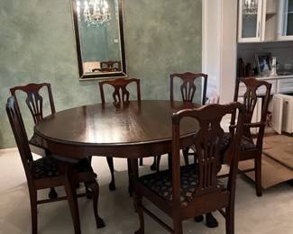 54" Round dining table with 6 chairs.  Has 4 leaves which are 10 1/2" each.  