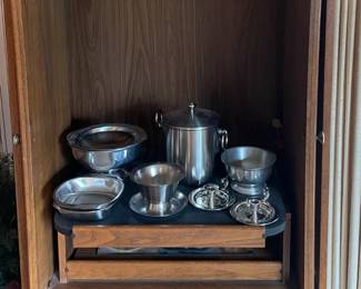 TV stand, pewter and stainless servingware.
