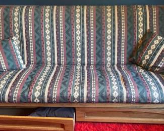 Futon with 2 large wooden drawers.