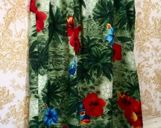 This Hawaiian dress, complete with tag, features colorful flowers and foliage. 