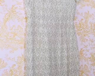 A pale, pastel green lace dress with a stand-up color and side closure. 