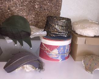 A nice collection of vintage hats, some with their boxes, and millinery flowers. 