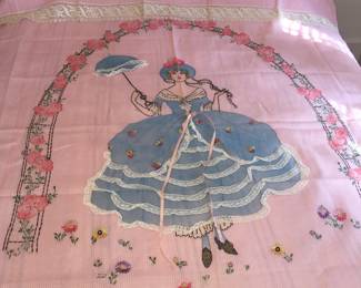 A truly unusual cotton bedspread featuring a gal in petticoat with a parasol surrounded by pink flowers. A pillow cover with more pink flowers is included. 