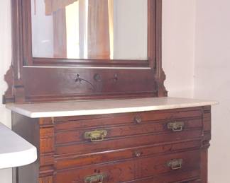 Eastlake-style dresser with marble top and three drawers offers lots of storage space. 
