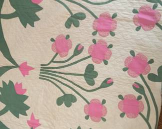 A stunning quilt with hand-stitched, appliqued flowers and leaves. An undated note found with the quilt states the quilt’s fish scale hand-sewn design is like that of a Civil War-era quilt. It noted the quilt is 100 years old thought it’s not known when it turned 100. 