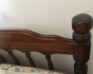 A close look at part of the wood headboard for a full bed. 