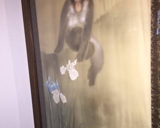 This unusual framed piece shows a baboon seemingly admiring the blooming irises. 