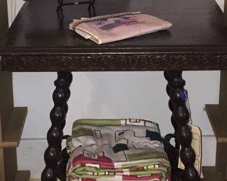 A parlor table topped with a snakeskin pocketbook,’dress gloves and a souvenir hankie holder from Washington DC. 