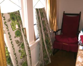 Bark-cloth like draperies and a padded rocking chair. 