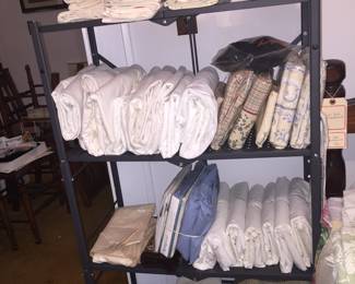 Just look at all those sheets and pillowcases. And, note the new sets in original packages. 