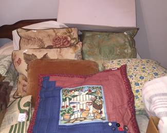 A few of the accent pillows and a wedge that at are offered for sale. 
M