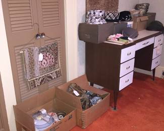 The boxes hold vintage and antique light fixtures ready to shed light in a new home or office. The table runner on the hanger would also look great on the foot of a bed. 