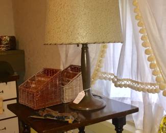 A side table with turned legs would fit in most any room. The classic lamp is topped with a fiberglass shade lashed to a frame.