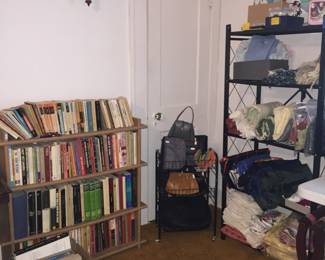 A corner full of goodness with books, handbags and totes, sewing supplies and more.  There’s even a wood luggage rack, one of two, tucked under the table. 