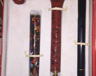 ... an Asian walking stick with carved handle and decorative cane. 