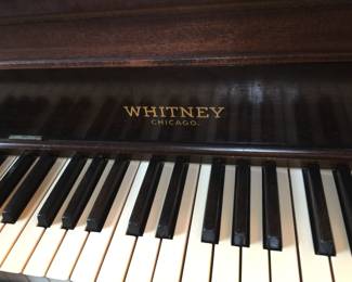 A Whitney grand piano in mahogany is a sure attention-grabber. 