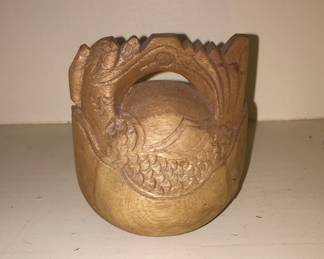 A carved piece resembles a large bell. 