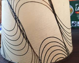 A fiberglass shade with black and gold swirls n